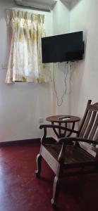 a room with a table and a chair and a window at Aliya Stay in Galle
