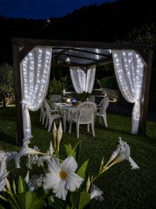 a table and chairs under a gazebo with lights at Villino Isò in La Spezia