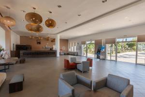 a lobby with couches and a table and chairs at Lunja Village - Agadir in Taghazout