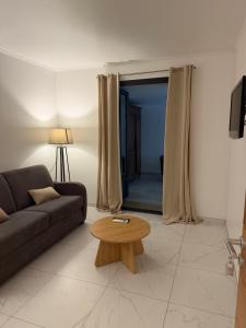 a living room with a couch and a coffee table at Kyrn Flor - Domaine Sant Antone in Corte