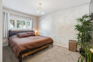 a bedroom with a bed and a window at Bright & Fully Renovated Retreat - Holiday Home in Saskatoon