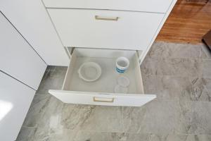a drawer in a kitchen with a cup of coffee at Bright & Fully Renovated Retreat - Holiday Home in Saskatoon +32 photos
