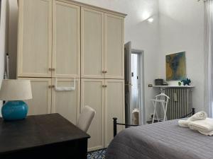 a bedroom with a bed and a desk and a cabinet at Suite LA BARONESSA in Lecce