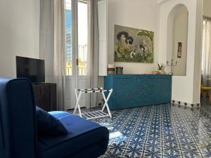a living room with a blue couch and a dresser at Suite LA BARONESSA in Lecce
