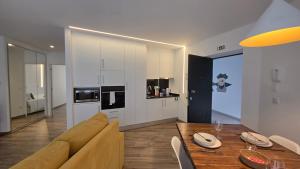 a living room with a dining table and a kitchen at A Proa do Moliceiro - iConik Design Apartments in Aveiro