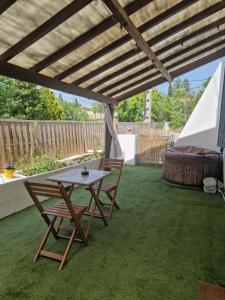 a patio with a table and chairs and a tent at Spa et lit baldaquin in Saint-Pargoire