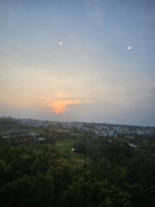 a view of a city with the sunset in the sky at TUỆ Home in Long Bình