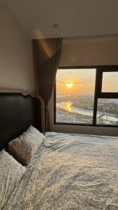 a bedroom with a bed with a view of the ocean at TUỆ Home in Long Bình