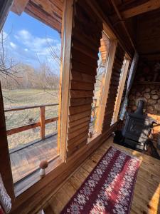 a view of a room with a window and a stove at Apple Tree Cabin (Friendship Land) in Şelari