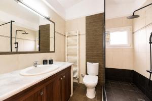 a bathroom with a sink and a toilet and a shower at VALLEY Premium House in Serres +11 photos