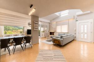 a living room with a couch and a table at VALLEY Premium House in Serres