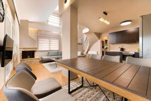 a dining room and living room with a table and chairs at VALLEY Premium House in Serres