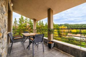 a balcony with a table and chairs and a view at VALLEY Premium House in Serres