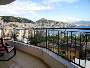 a balcony with a view of a city at Panoramic Sea View Apartment Saranda in Sarandë