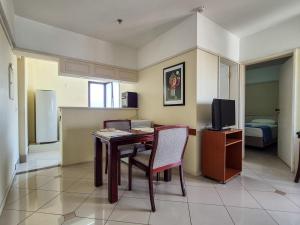 a dining room with a table and a television at Apartment 116 - Jundiaí in Jundiaí +12 photos