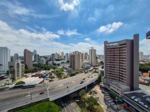 a view of a city with a highway and buildings at Apartment 116 - Jundiaí in Jundiaí