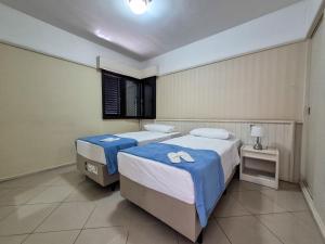 a bedroom with two beds and a window at Apartment 116 - Jundiaí in Jundiaí