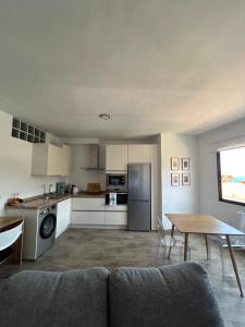 a kitchen with a couch and a table in a room at Apartamento moderno con encanto in Los Realejos