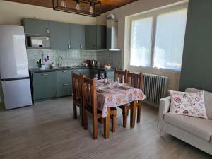 a kitchen and dining room with a table and chairs at Casa Paolina in Premeno