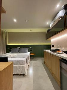 a large bedroom with a bed and a kitchen at Ap 101 concept BobZ in Barrinha
