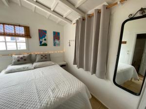 a bedroom with a white bed and a mirror at Boat House in Loutraki