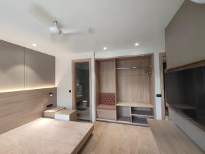 a room with a bedroom with a bed and a television at Hotel Radha residency inn in Chhatikara