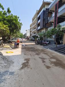 an empty street in front of a building at Hotel Radha residency inn in Chhatikara +4 photos