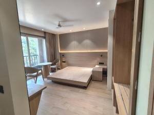 a bedroom with a bed and a table in a room at Hotel Radha residency inn in Chhatikara
