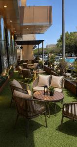 a patio with chairs and tables on a balcony at Nilufer AlHada Hotel - فندق نيلوفر الهدا in Taif