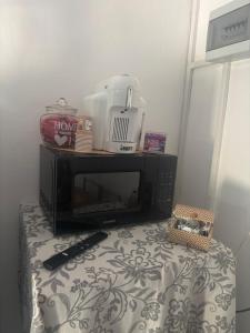 a microwave sitting on top of a table at Casa Elisa 10 B in Bellaria-Igea Marina +18 photos