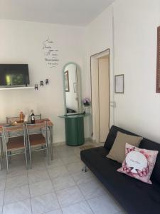 a living room with a couch and a table at Casa Elisa 10 B in Bellaria-Igea Marina