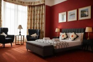 a bedroom with a bed and a couch and a chair at Gladstone House in Edinburgh