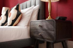 a bedroom with a bed with a night stand with a drawer at Gladstone House in Edinburgh