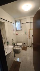 a bathroom with a sink and a toilet and a tub at Al Piccolo Pontile Como lake in Mandello del Lario