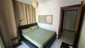 a small bedroom with a bed in a room at Al Piccolo Pontile Como lake in Mandello del Lario