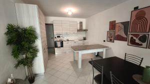 a kitchen with a table and a dining room at Al Piccolo Pontile Como lake in Mandello del Lario