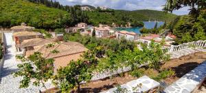 an aerial view of a village on a hill next to the water at Edem Studios in Syvota