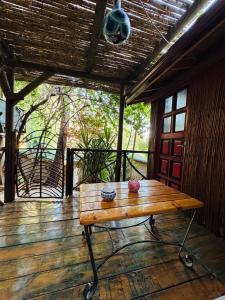 a wooden bench sitting on a wooden deck at Turan Hill Lounge in Faralya