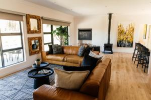 a living room with a couch and a table at Pause Guesthouse in Clarens