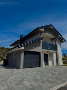 a detached house with a garage in a driveway at NMS Promet in Mrkonjić Grad