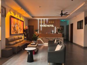 a living room with a couch and chairs and a table at Khách sạn Vin Hồ in Thế Rương