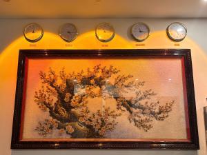 a picture with four clocks on a wall at Khách sạn Vin Hồ in Thế Rương