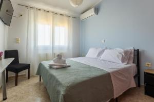 a bedroom with a bed with a stuffed animal on it at Aeolus Villa Chios in Chios
