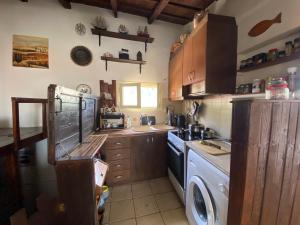 a kitchen with a washing machine and a washer at Boat House in Loutraki +23 photos