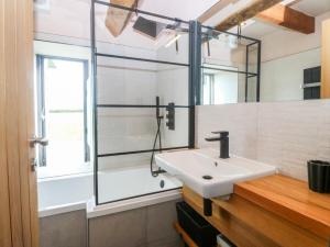 a bathroom with a sink and a glass shower at Seren Fach in Pwllheli +29 photos