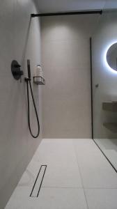 a bathroom with a shower and a sink at Ianos Living Spaces - 03 in Korinthos +17 photos