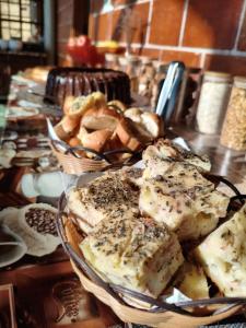 a plate of food on a table with bread at Pousada AlpenRose in Campos do Jordão +40 photos