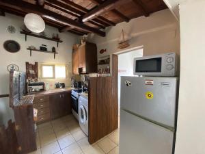 a kitchen with a refrigerator and a washing machine at Boat House in Loutraki