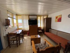 a living room with a couch and a table at Boat House in Loutraki