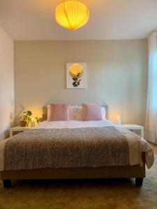 a bedroom with a large bed with a yellow lamp at Escape to Lytham St. Annes in Lytham St Annes